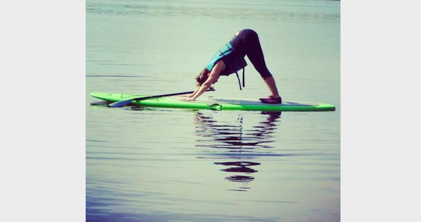 Joy Nicholson performing stand up paddleboard yoga. - CONTRIBUTED