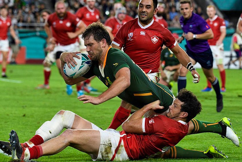 South Africa's centre Frans Steyn (C) dives a scores a try past Canada's centre Ciaran Hearn (down) and  Canada's scrum-half Phil Mack (up)  during the Japan 2019 Rugby World Cup Pool B match between South Africa and Canada at the Kobe Misaki Stadium in Kobe on October 8, 2019.  