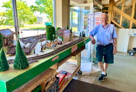 Dave Jackman stands next to a large toy train track, which is displayed in the window at his Romar Enterprises Ltd. store. After 46. years in business, Jackman officially closed on June. 15.