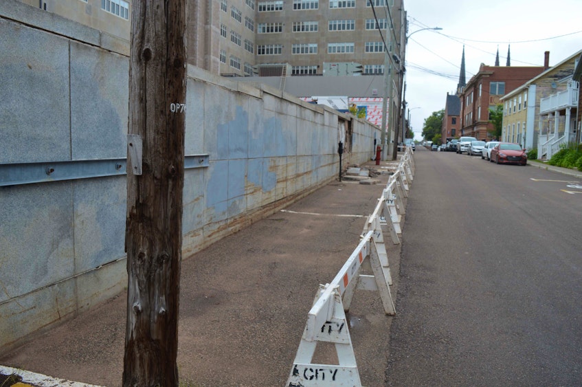 Charlottetown’s public works department has blocked off a section of Sydney Street that runs along the side of the Dominion Building after chunks of concrete broke off the building on June 29. - Dave Stewart