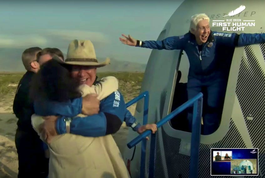 Billionaire businessman Jeff Bezos and pioneering female aviator Wally Funk emerge from their capsule after their flight aboard Blue Origin's New Shepard rocket on the world's first unpiloted suborbital flight near Van Horn, Texas, on Tuesday, July 20, 2021 in a still image from video. - Blue Origin / Handout via Reuters