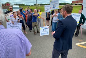 Nova Scotia Premier Iain Rankin is heckled during a visit to Amherst Tuesday during which he announced non-commercial Nova Scotia drivers will no longer have to pay the toll to use the Cobequid Pass after Oct. 1.