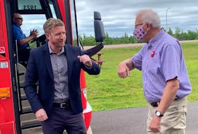 Nova Scotia Premier Iain Rankin prepares to bump elbows with Cumberland North Liberal candidate and former MP Bill Casey during a campaign stop in Amherst on Tuesday. Darrell Cole - SaltWire Network