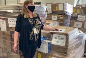 Naomi Shelton, director of communications and policy for Elections Nova Scotia, stands in front of election packages ready to be delivered to the 55 provincial ridings last week before the election was called.