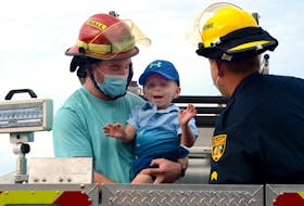 Two-year-old Denver Genge got to see St. John's Regional Fire Department fire trucks up close Monday. Keith Gosse/The Telegram