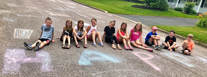 Some of the Sydney River neighbourhood children who have been helping draw positive messages, art and games with chalk on the street to cheer neighbours up and remind people everyone is different and that should be celebrated. Pictured here from left are, Carey Wadden, Violet MacLean, Lucy MacLean, Ana Harpell, Maggie MacArthur, Sophie Foote, Alexa Williams, Ewan Wadden, Max Harpell and Henry MacLean.