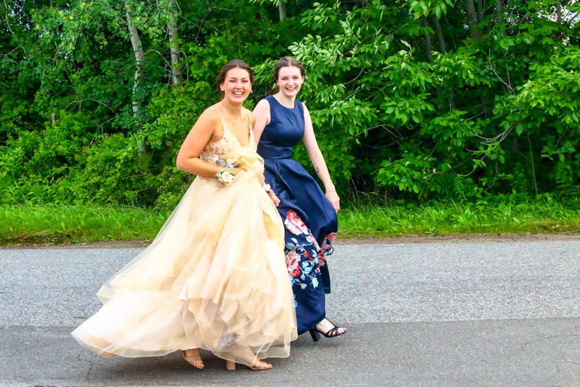 Class of 2021 valedictorian Lola Velden walks with her best friend, Kiera Huntley, to the West Hants sports complex for prom.
JIM IVEY
