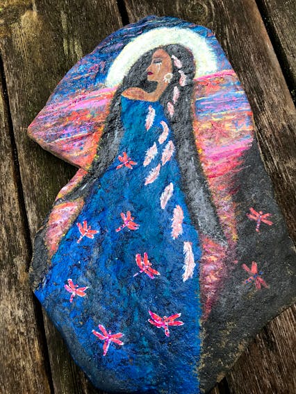 Isn't this rock magnificent?  Kim Dickinson painted this rock with acrylic in honour of the Indigenous children who never returned home. It goes with a stirring poem she wrote, Whispers & Wings.