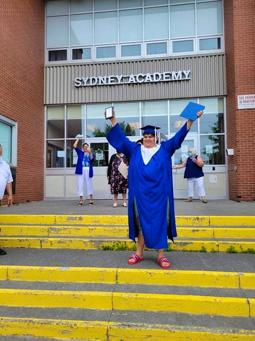 Gregory Francis stands on the front steps of Sydney Academy after walking the stage at his graduation on June 22, holding his diploma in one hand and his plaque for making highest honours for the past three years. CONTRIBUTED 