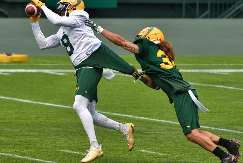 Wide receiver Kenny Stafford (8) makes the catch on defensive halfback Aaron Grymes (36) during Edmonton Elks training camp at Commonwealth Stadium in Edmonton on July 16, 2021.