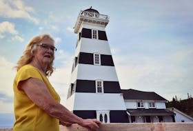 Carol Livingstone admires the iconic West Point Lighthouse in P.E.I., which is one of the most haunted places in Canada.