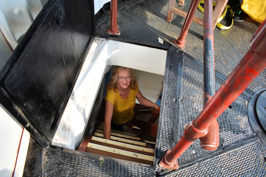 Carol Livingstone climbs the steep, narrow staircase (that gets narrower at the top of the five levels) for an eagle-eye view of the Fairy Trails below.