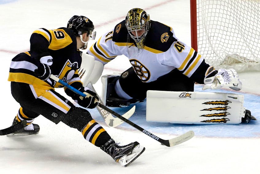 Pittsburgh Penguins' Jared McCann (19) prepares to put a shot around Boston Bruins goaltender Jaroslav Halak (41) in Pittsburgh, Sunday, March 10, 2019