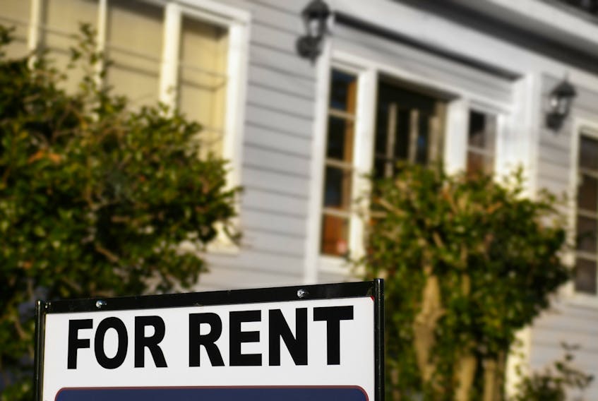 A For Rent sign outside a house.