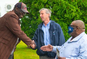 Progressive Conservative leader Tim Houston and Preston candidate Archy Beals shake hands with Marlowe Smith as they campaign in North Preston on Thursday, July 22, 2021.