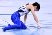 Japan's Kohei Uchimura reacts after falling down during the horizontal bars event of the artistic gymnastics men's qualification during the Tokyo 2020 Olympic Games.