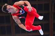  Artur Dalaloyan of the Russian Olympic Committee in action on the parallel bars.