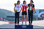  Silver medallist Netherlands’ Annemiek Van Vleuten, Gold medallist Austria’s Anna Kiesenhofer and bronze medallist Italy’s Elisa Longo Borghini pose for pictures on the podium during the medal ceremony for the women’s cycling road race of the Tokyo 2020 Olympic Games. (Photo by Greg Baker / AFP)