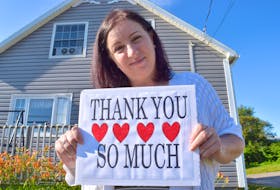 Shawna Wilson of Glace Bay stands in front of her home in Glace Bay with a message of gratitude to the public. A single mother only days away from their home going into foreclosure, she said the hearts of the public stepped up to help and they’ll be forever grateful. Sharon Montgomery-Dupe/Cape Breton Post