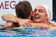 Kaylee McKeown of Team Australia is congratulated by Kylie Masse of Team Canada after winning the gold medal in the Women's 100m Backstroke Final on day four of the Tokyo 2020 Olympic Games at Tokyo Aquatics Centre on July 27, 2021 in Tokyo, Japan.