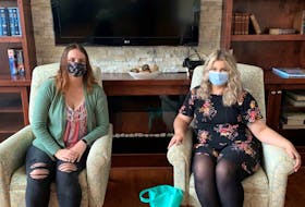 Brianne Burns from Maurices (left) sits with Parkland Truro’s Bree-Lynn Pelly, with a bag of masks bought and donated by Maurices customers for Parkland residents. - Photo Contributed