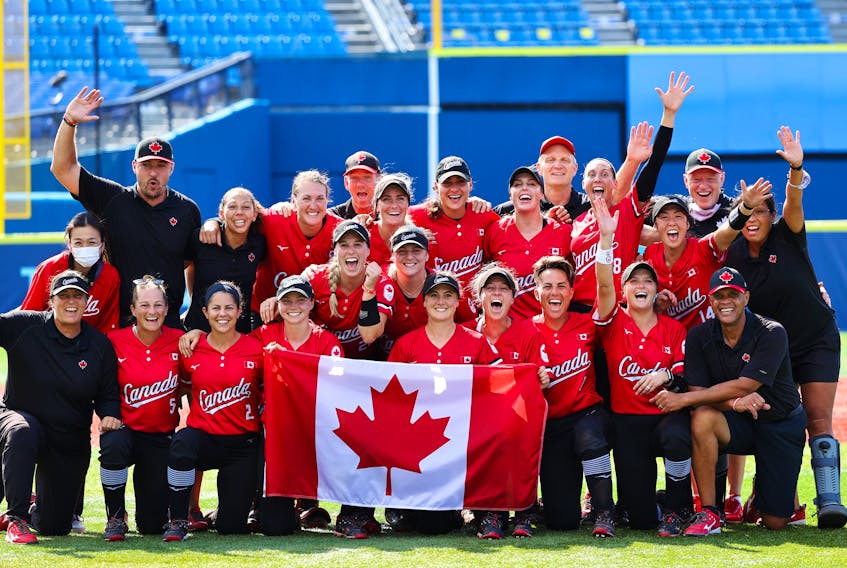 The Canadian women’s softball team, including head coach Mark Smith of Falmouth, front row, right, celebrates after beating Mexico 3-2 to win the bronze medal at the Tokyo Olympics on Tuesday. REUTERS/Jorge Silva