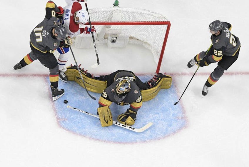 File photo/ Marc-Andre Fleury #29 of the Vegas Golden Knights gets assistance from Nicolas Roy #10 and Nick Holden #22 while blocking a shot by Joel Armia #40 of the Montreal Canadiens during the second period in Game Five of the Stanley Cup Semifinals at T-Mobile Arena on June 22, 2021 in Las Vegas, Nevada. The Canadiens beat the Golden Knights 4-1.