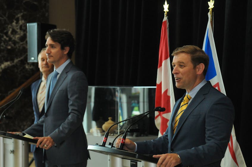Premier Andrew Furey (right) speaks to reporters in St. John’s on July 29. Looking on are Prime Minister Justin Trudeau (centre) and federal Natural Resources Minister Seamus O’Regan. — Joe Gibbons/The Telegram
