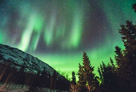 The Northern Lights or Aurora Borealis - seen here in the Yukon - occurs when charged particles stream from the sun during a solar flare or coronal mass ejection event intersects the Earth's magnetosphere. - Unsplash/Leonard Laub