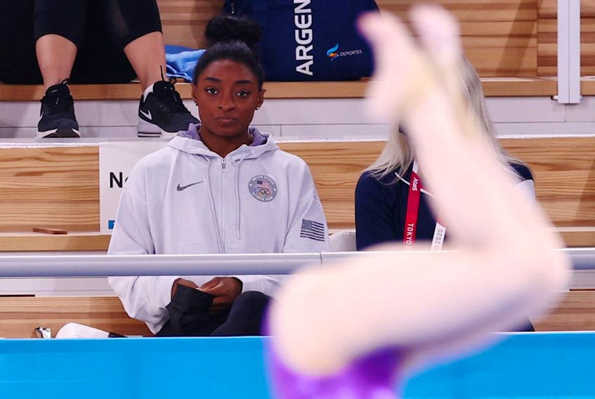  Simone Biles of the United States watches from the stands.