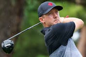 Mackenzie Hughes of Team Canada plays his shot from the 18th tee during the first round of the Men's Individual Stroke Play.