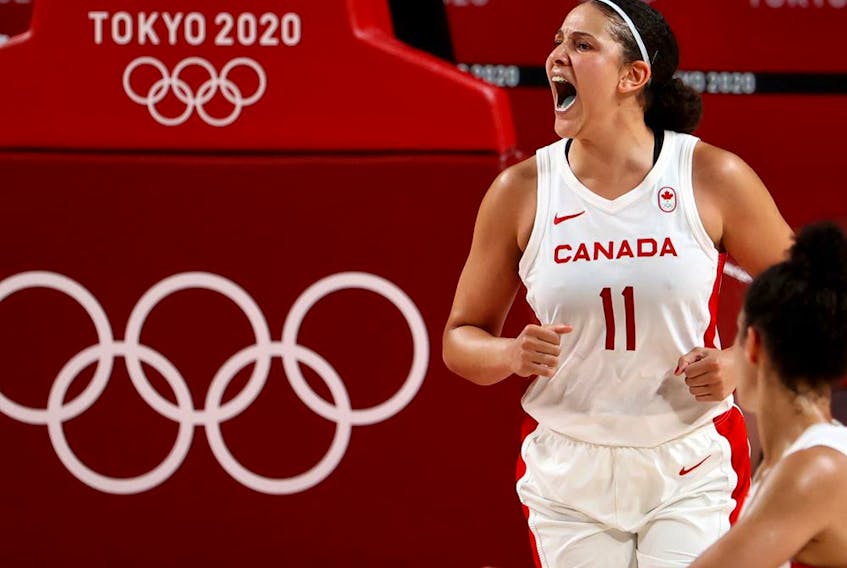 Natalie Achonwa of Canada celebrates after scoring a basket in Olympic action.