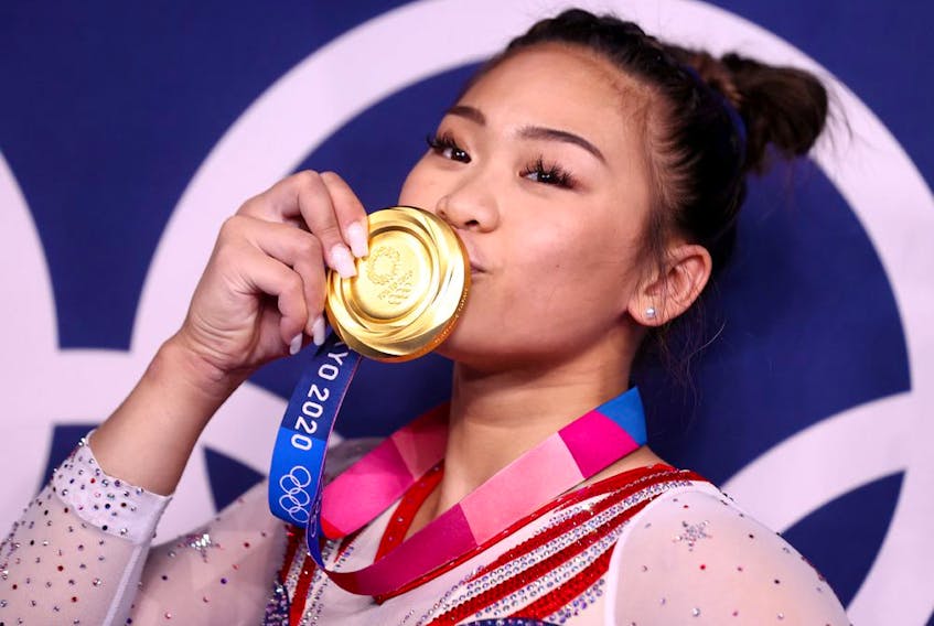  Gold medallist Sunisa Lee of the United States kisses her medal.