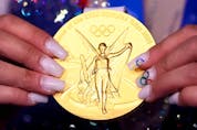  Gold medallist Sunisa Lee of the United States holds her medal.