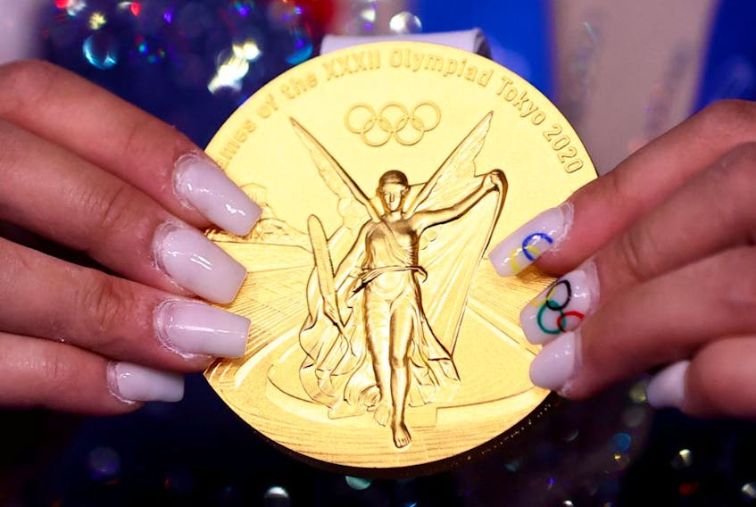  Gold medallist Sunisa Lee of the United States holds her medal.