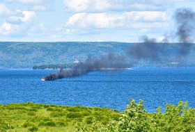A small boat caught on fire and sank near Cape Breton’s St. Georges Channel on Thursday. Ken Thorneycroft took this photo from his deck at Leonards Pond about two kilometres east of the Dundee Resort. CONTRIBUTED/KEN THORNEYCROFT