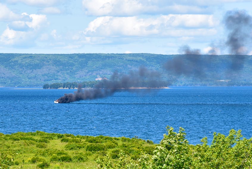 A small boat caught on fire and sank near Cape Breton’s St. Georges Channel on Thursday. Ken Thorneycroft took this photo from his deck at Leonards Pond about two kilometres east of the Dundee Resort. CONTRIBUTED/KEN THORNEYCROFT