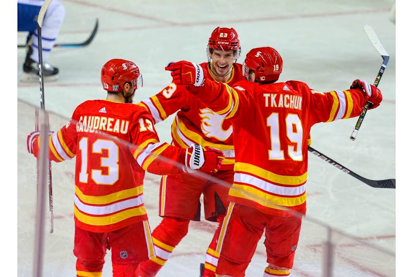 Calgary Flames forward Johnny Gaudreau celebrates with teammates Sean Monahan and Matthew Tkachuk after scoring a goal against the Toronto Maple Leafs in this photo from Jan. 26.