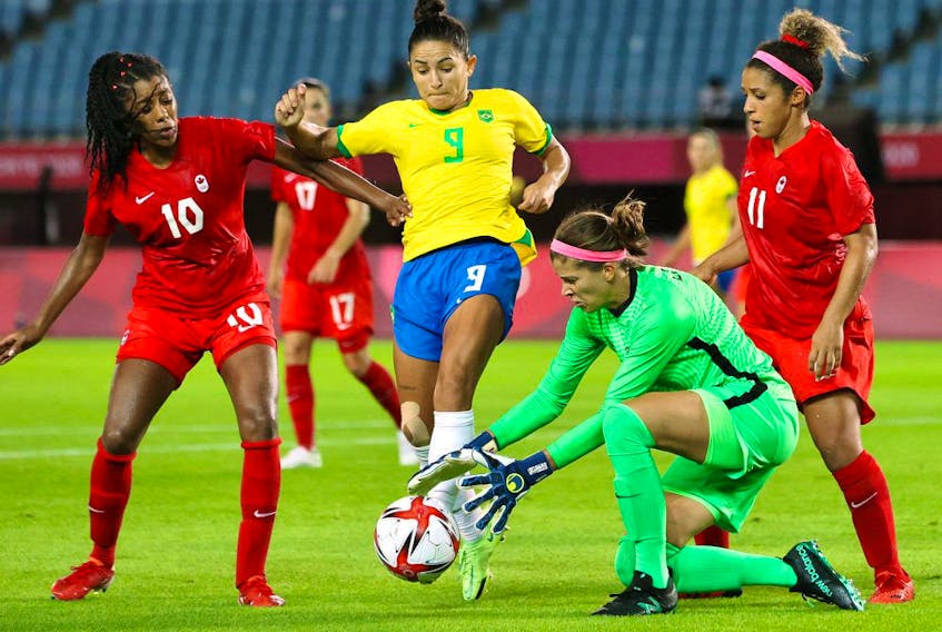 Stephanie Labbe #1 of Team Canada collects the ball whilst under pressure from Debinha #9 of Team Brazil during the Women's Quarter Final match between Canada and Brazil on day seven of the Tokyo 2020 Olympic Games at Miyagi Stadium on July 30, 2021 in Rifu, Miyagi, Japan. 