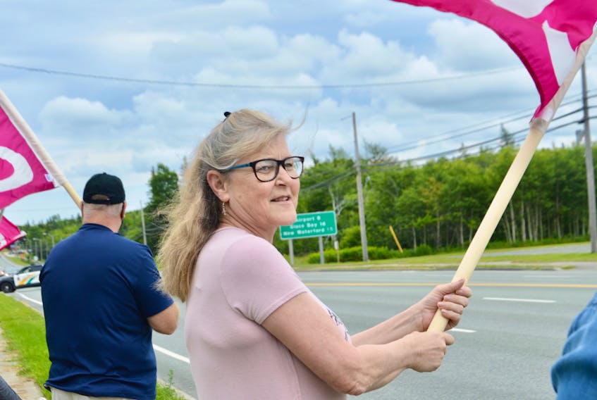 As a police vehicle drives into the parking lot of police headquarters on Grand Lake Road, picketers, including Special Const. Sharon MacLeod, were in front on Friday protesting the CBRM’s decision to not reclassify special constables so they’re paid equally with their counterparts across the province. ELIZABETH PATTERSON/CAPE BRETON POST