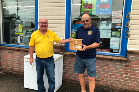 Bryson Crowell, left, and Jim Balcom are shown with one of the boxes where participants place toonies to enter Middleton Rotary Club’s weekly Goldmine 50/50 Draw. The boxes are located in 20 vendor locations from Aylesford to Annapolis. Contributed