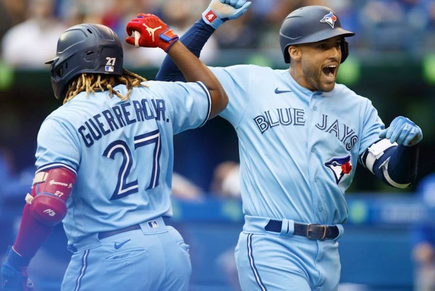 Blue Jays' George Springer (right) celebrates a home run with teammate Vladimir Guerrero Jr. (27) in the first inning  against the Royals at Rogers Centre in Toronto, Saturday, July 31, 2021.