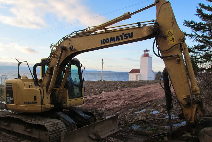 A tractor sits idle on the Black Rock Point Lighthouse property in Black Rock, Victoria County. According to property neighbour Dr. William Harless, the tractor has been used to prepare for the possible construction of a private RV park. IAN NATHANSON • CAPE BRETON POST