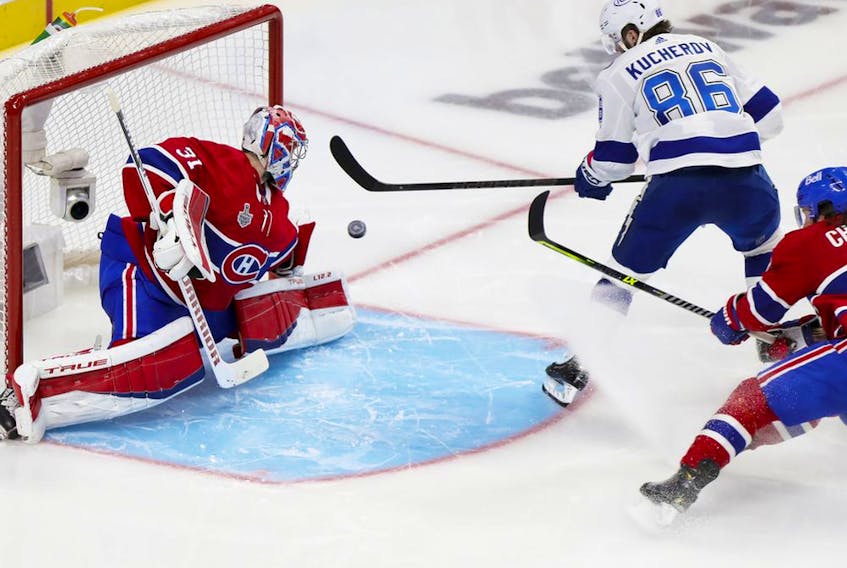 Tampa Bay Lightning's Nikita Kucherov shoots the puck past Canadiens' Carey Price and defenceman Ben Chiarot for a goal during the second period of the Stanley Cup Final in Montreal on Friday, July 2, 2021.  