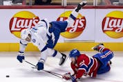 Canadiens' Joel Armia (40) takes Tampa Bay Lightning's Mathieu Joseph (7) down with him after a big hit during Game 3 of the Stanley Cup Final in Montreal on Friday, July 2, 2021. 
