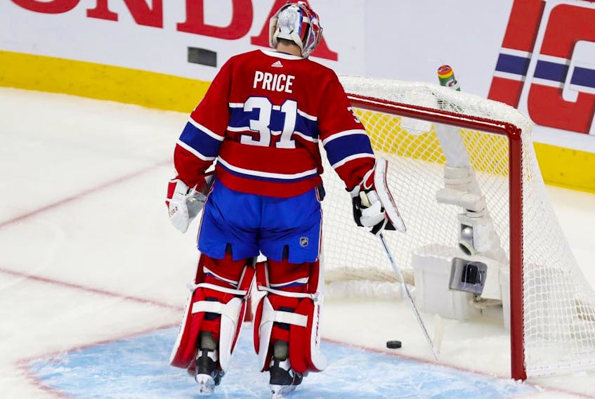 Canadiens' Carey Price fishes the puck out of the net after goal by Tampa Bay Lightning's Victor Hedman during the first period of Game 3 of the Stanley Cup Final in Montreal on Friday, July 2, 2021.  