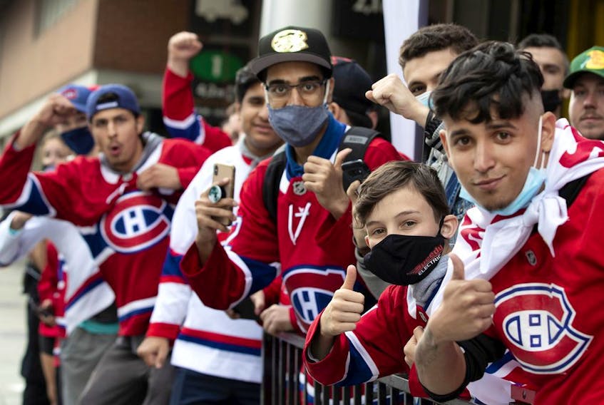 Fans line St-Antoine St. to catch a glimpse of the Canadiens arriving for Game 3 of the Stanley Cup Final against the Tampa Bay Lightning in Montreal on Friday, July, 2, 2021.  
