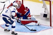 Tampa Bay Lightning's Nikita Kucherov (86) lifts the puck over Canadiens goaltender Carey Price (31) during Game 3 of the Stanley Cup Final in Montreal on Friday, July 2, 2021.  