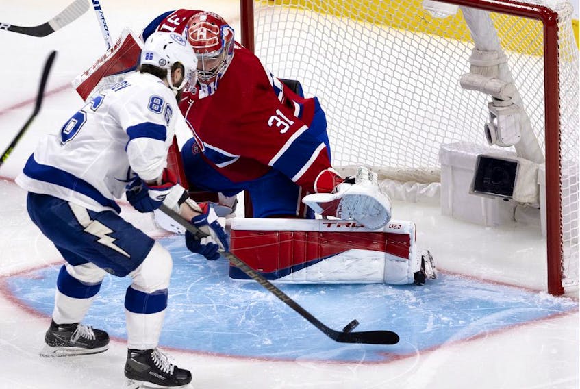 Tampa Bay Lightning's Nikita Kucherov (86) lifts the puck over Canadiens goaltender Carey Price (31) during Game 3 of the Stanley Cup Final in Montreal on Friday, July 2, 2021.  