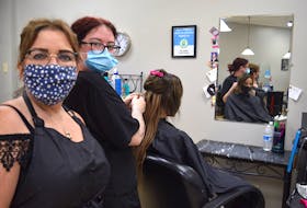 Tracy Wood, left, and Jessica Elliott, hairstylists at Scissor Haven Salon and Barber Shop, are happy to once again be greeting clients such as Angelina Gouchie who believes the hair industry should be considered an essential service because of the mental health benefits it offers. Harry Sullivan 